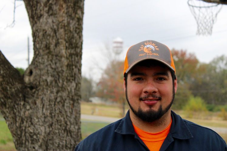 Josh Perez in his Say Bugman cap — the New Boston water tower over his shoulder